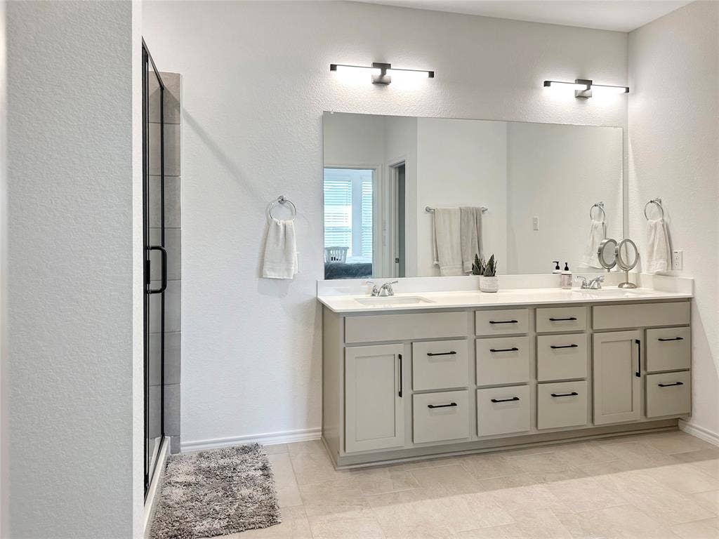 2117 Proteus Drive, Haslet, TX 76052 Bathroom with vanity, a shower with shower door, and tile patterned floors