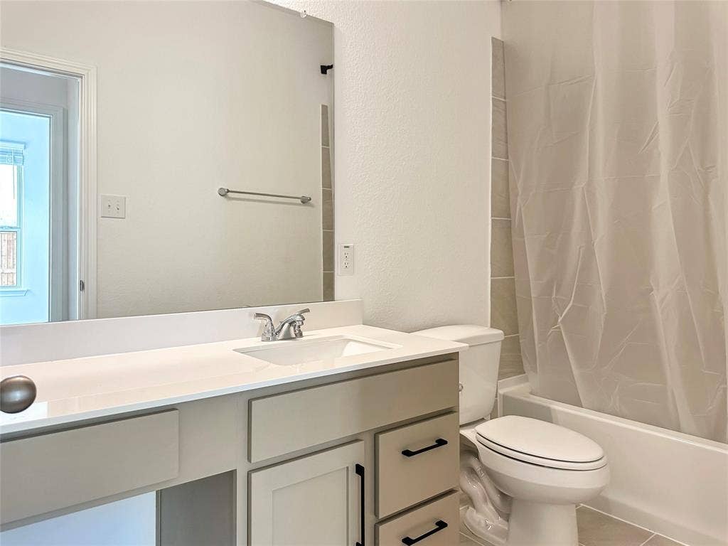 2117 Proteus Drive, Haslet, TX 76052 Full bathroom featuring tile patterned flooring, toilet, shower / tub combo, and vanity
