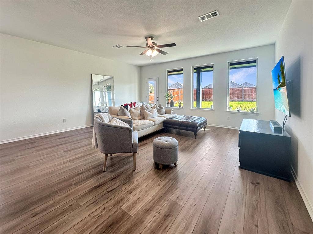 2117 Proteus Drive, Haslet, TX 76052 Living room featuring dark wood-type flooring, a textured ceiling, and ceiling fan