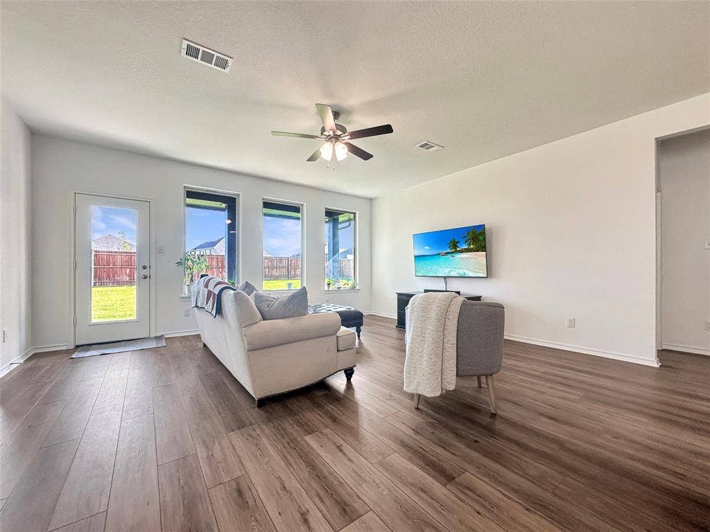 2117 Proteus Drive, Haslet, TX 76052 Living room with dark hardwood / wood-style flooring, a healthy amount of sunlight, and ceiling fan