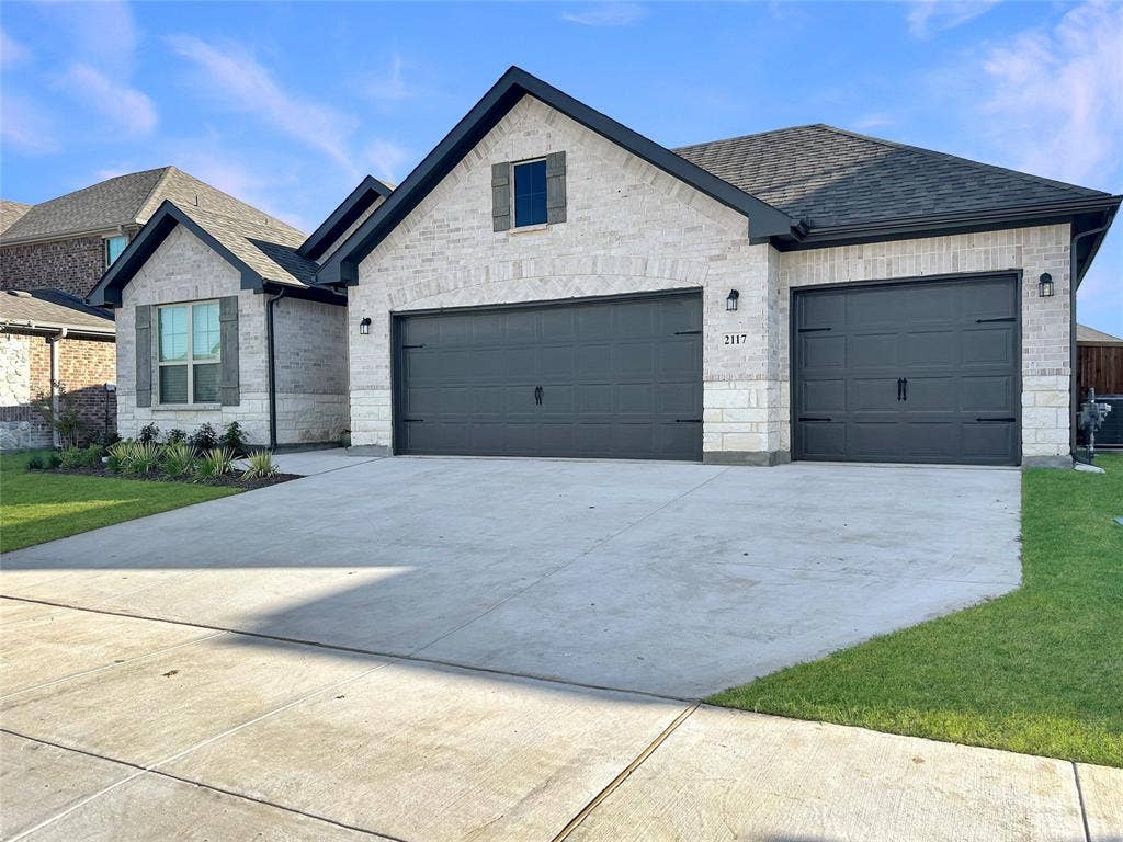 2117 Proteus Drive, Haslet, TX 76052 View of front of home featuring a garage and a front lawn