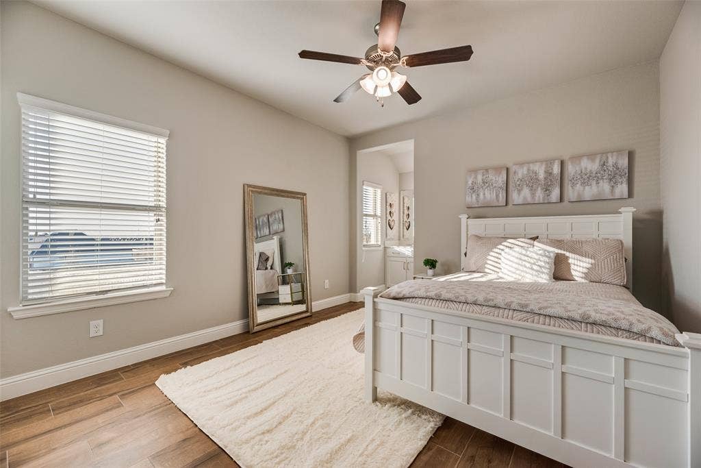 Wood-finish flooring with neutral wall tones and a ceiling fan
