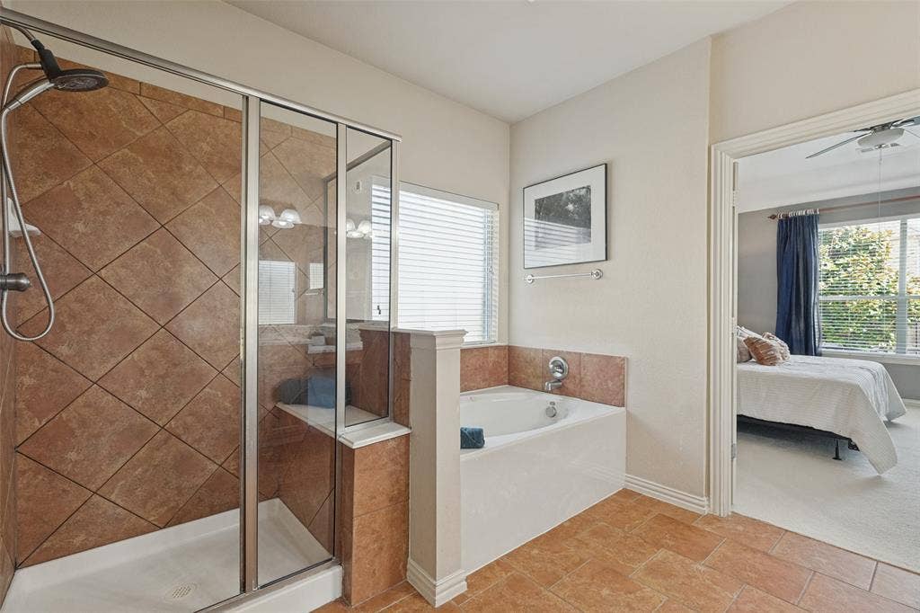 10796 Astoria Drive, Frisco, TX 75035 “Private primary bath features a separate soaking tub and tiled walk-in shower, creating a relaxing ensuite retreat just steps from the primary bedroom.