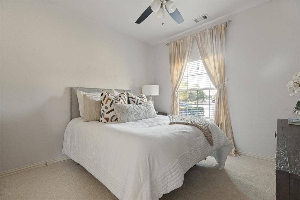 10796 Astoria Drive, Frisco, TX 75035 Secondary bedroom offers brand-new carpet, a ceiling fan, and a large window providing plenty of natural light.