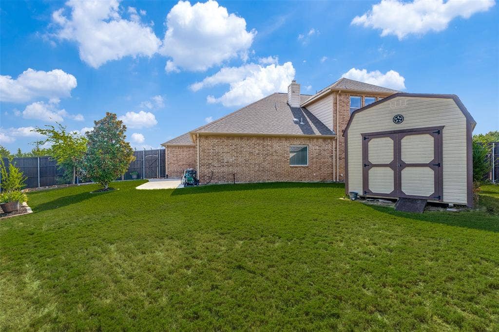 10796 Astoria Drive, Frisco, TX 75035 Expansive fenced backyard offers plenty of green space for outdoor activities, pets, or entertaining, plus a convenient storage shed for lawn and gardening equipment.