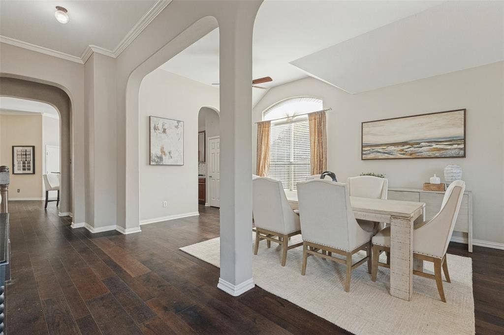 10796 Astoria Drive, Frisco, TX 75035 Another view of the spacious dining area highlights the soaring ceilings, beautiful architectural arches, rich hardwood floors, and large windows that bring in abundant natural light.