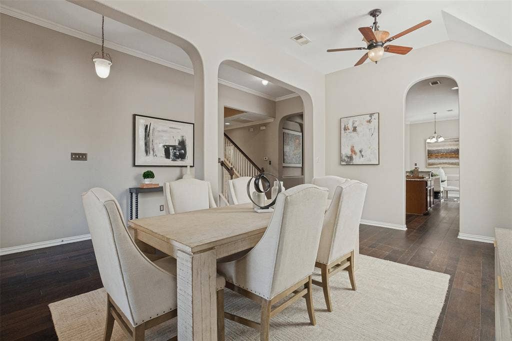 10796 Astoria Drive, Frisco, TX 75035 The formal dining room flows seamlessly into the heart of the home, with soaring ceilings, graceful archways, rich hardwood floors, and an open layout ideal for entertaining.