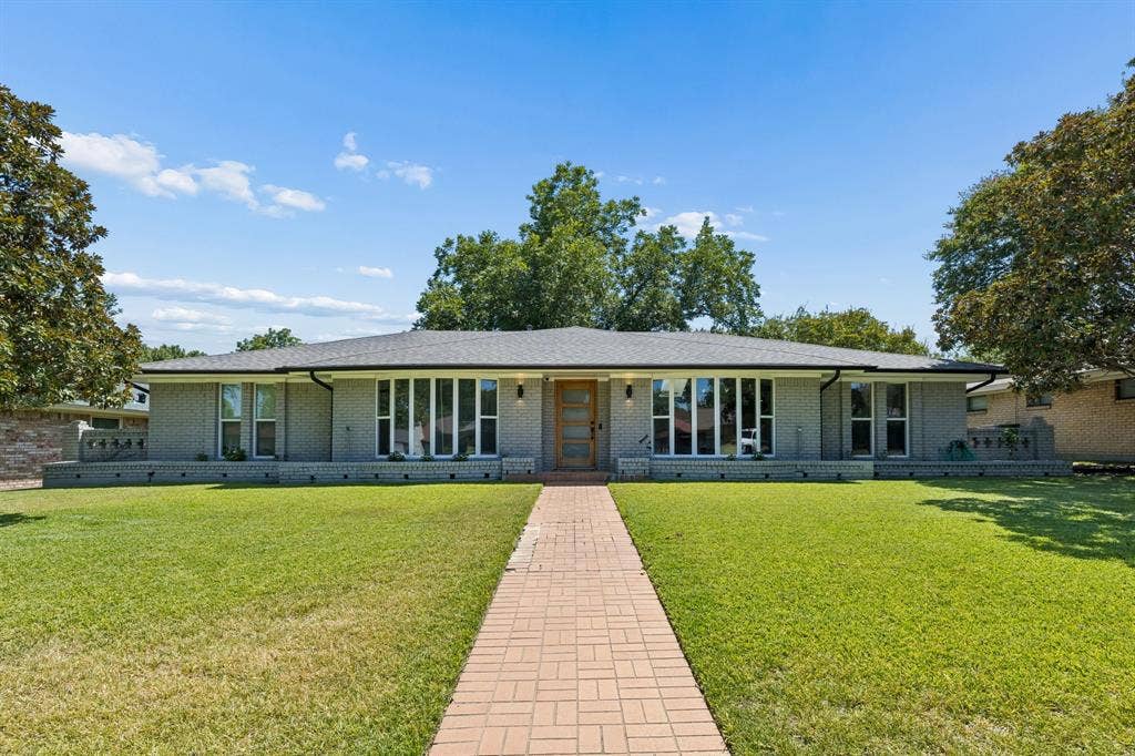2408 Grandview Drive, Plano, TX 75075 Gray brick exterior with a dark shingle roof