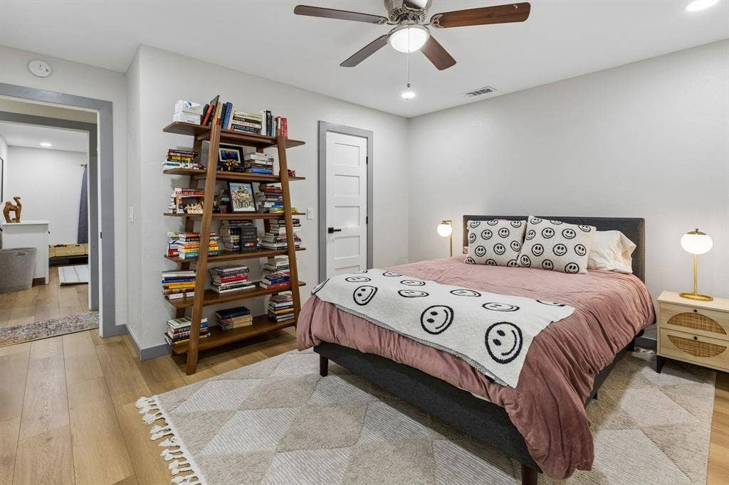 2408 Grandview Drive, Plano, TX 75075 Recessed lighting, ceiling fan with wood-finish blades, wood-finish flooring, white paneled door with black hardware, and an additional room entrance with grey trim