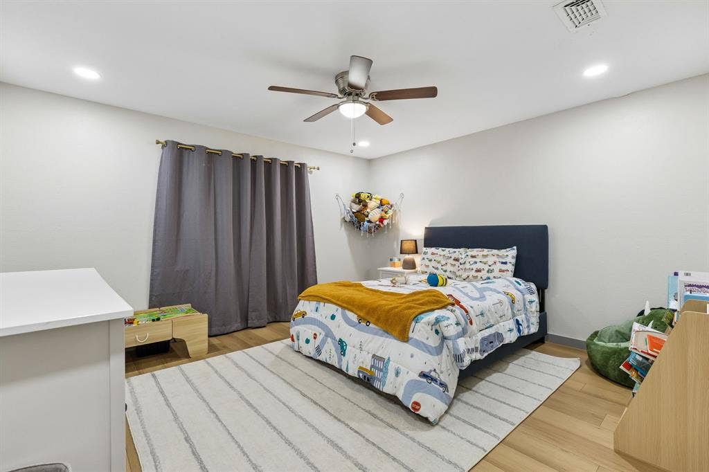 2408 Grandview Drive, Plano, TX 75075 Recessed ceiling lighting, ceiling fan with light, wood-finish flooring, and a window with curtain rod