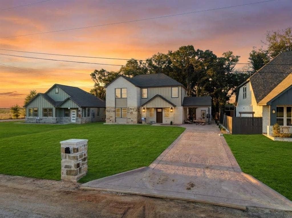 103 Water Oak Road, Trinidad, TX 75163 Contemporary home featuring a stone and stucco exterior, dark roof, and covered entry