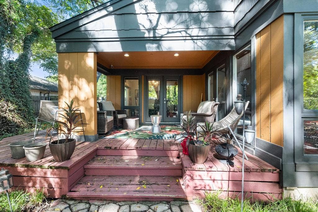 656 The Meadows Parkway, DeSoto, TX 75115 Multi-level wood deck with steps, covered patio with recessed lighting, double glass doors, and large picture windows