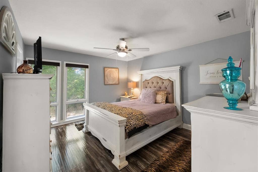 656 The Meadows Parkway, DeSoto, TX 75115 Wood-finish flooring, multiple windows, ceiling fan, and built-in dresser