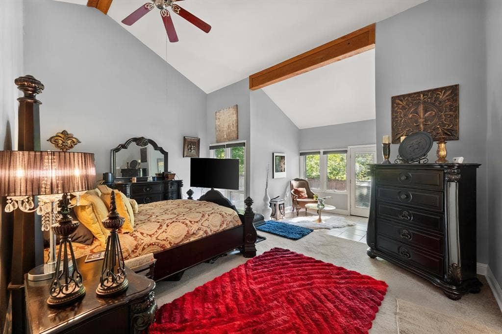 656 The Meadows Parkway, DeSoto, TX 75115 Vaulted ceiling with exposed wood beams, ceiling fan, tile flooring, and double patio doors