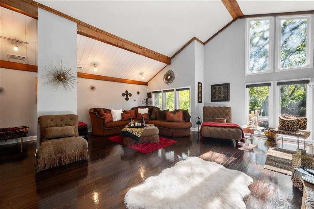 656 The Meadows Parkway, DeSoto, TX 75115 Vaulted ceiling with exposed wood beams, wood-finish flooring, and expansive windows