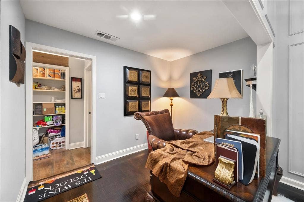 656 The Meadows Parkway, DeSoto, TX 75115 Deep wood-finish flooring, built-in shelving, white trim work, and light-toned wall finishes