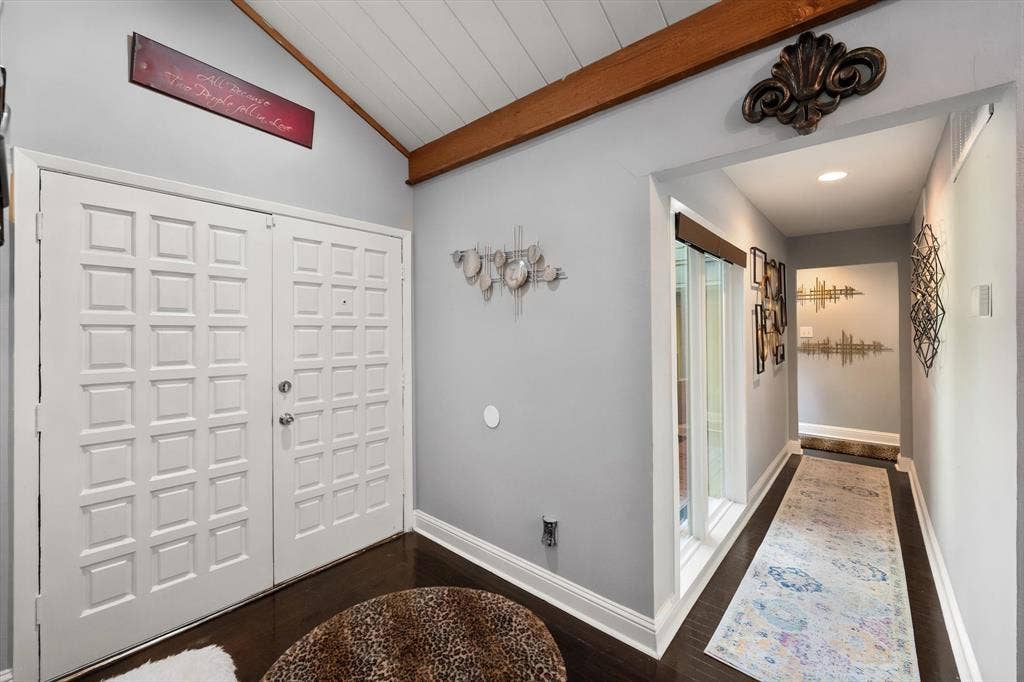 656 The Meadows Parkway, DeSoto, TX 75115 Vaulted wood-paneled ceiling with an exposed wood beam, dark wood-finish flooring, and white double entry doors with square paneling
