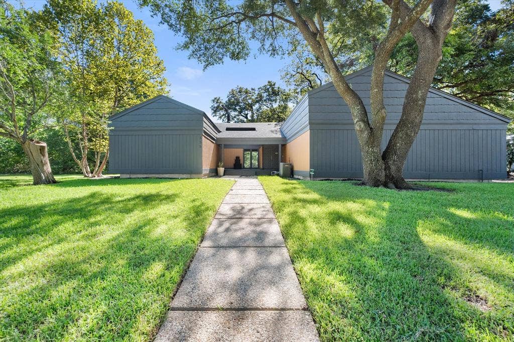 656 The Meadows Parkway, DeSoto, TX 75115 Modern exterior with a central entryway, a concrete walkway, and surrounding green lawn