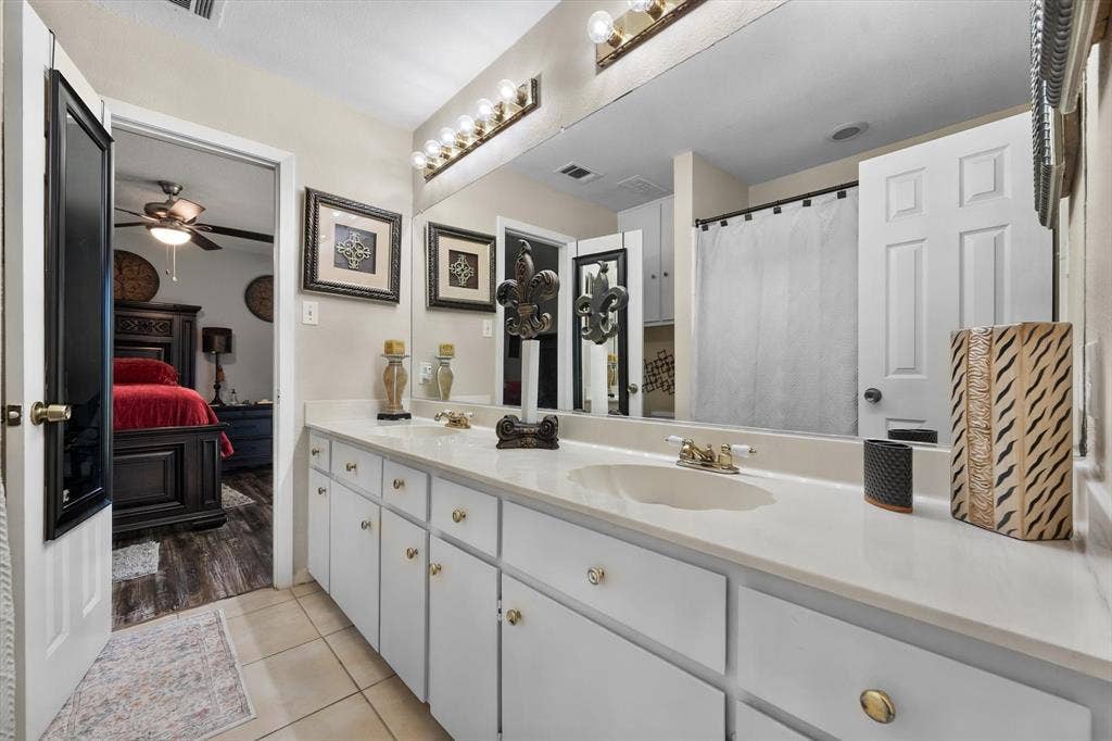 656 The Meadows Parkway, DeSoto, TX 75115 Dual vanity with white cabinetry, light-colored countertops, and integrated sinks