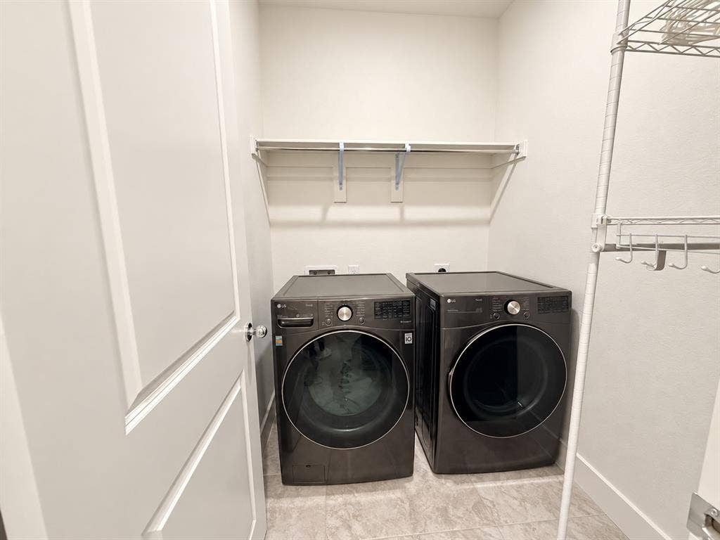 1613 Sandhill Lane, Celina, TX 75009 Laundry area with a permanent shelf and front-loading appliances