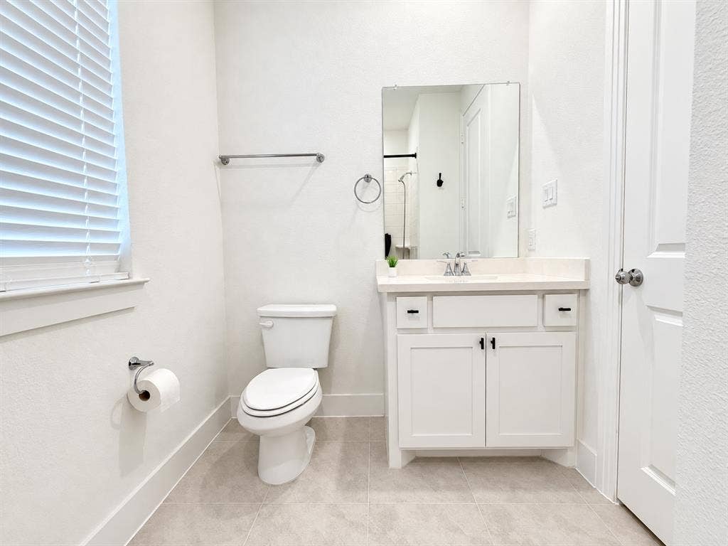 1613 Sandhill Lane, Celina, TX 75009 White vanity with a single basin, light-colored countertop, and dark hardware