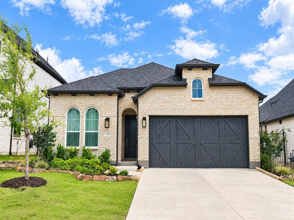 1613 Sandhill Lane, Celina, TX 75009 Light-toned brick exterior with a dark shingle roof