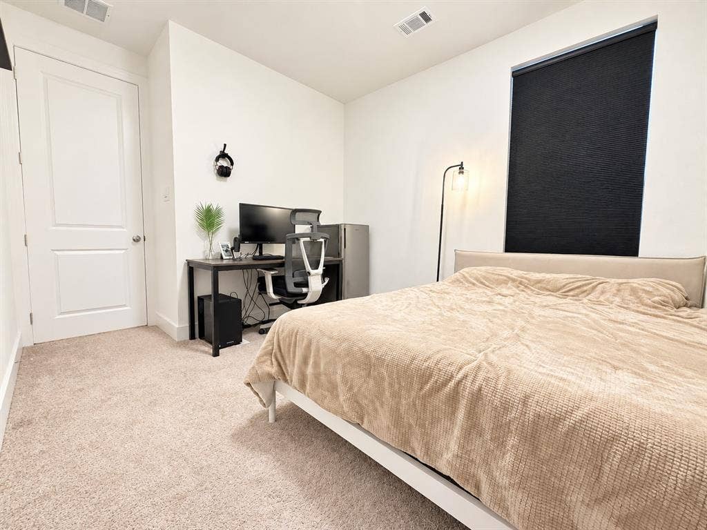 1613 Sandhill Lane, Celina, TX 75009 Neutral-toned carpet flooring, white painted walls, and a contemporary white two-panel door with a silver knob
