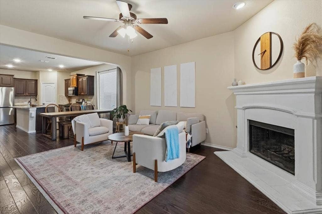 1713 Falling Star Drive, Fort Worth, TX 76052 Living area featuring a fireplace with a white mantel, dark wood-finish flooring, and recessed lighting