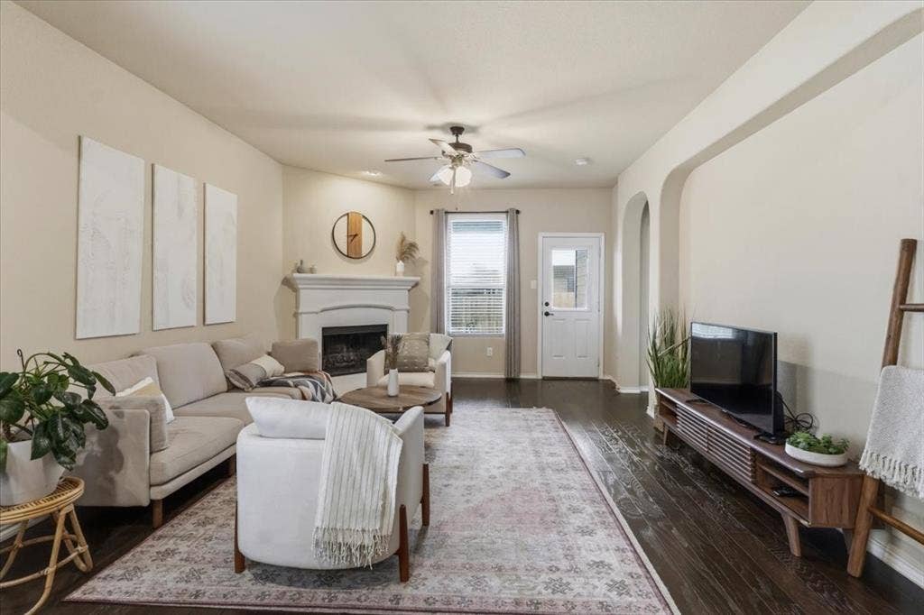 1713 Falling Star Drive, Fort Worth, TX 76052 Wood-finish flooring throughout, a white-mantled fireplace, and arched doorways