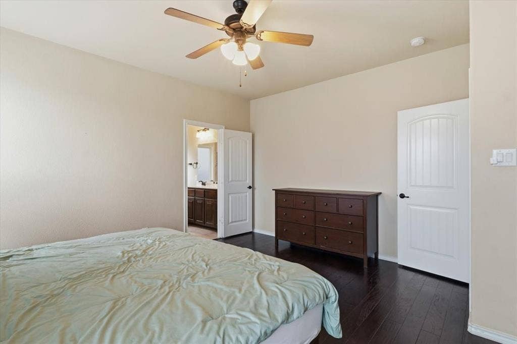 1713 Falling Star Drive, Fort Worth, TX 76052 Dark wood-finish flooring, ceiling fan with integrated lighting, and white paneled doors