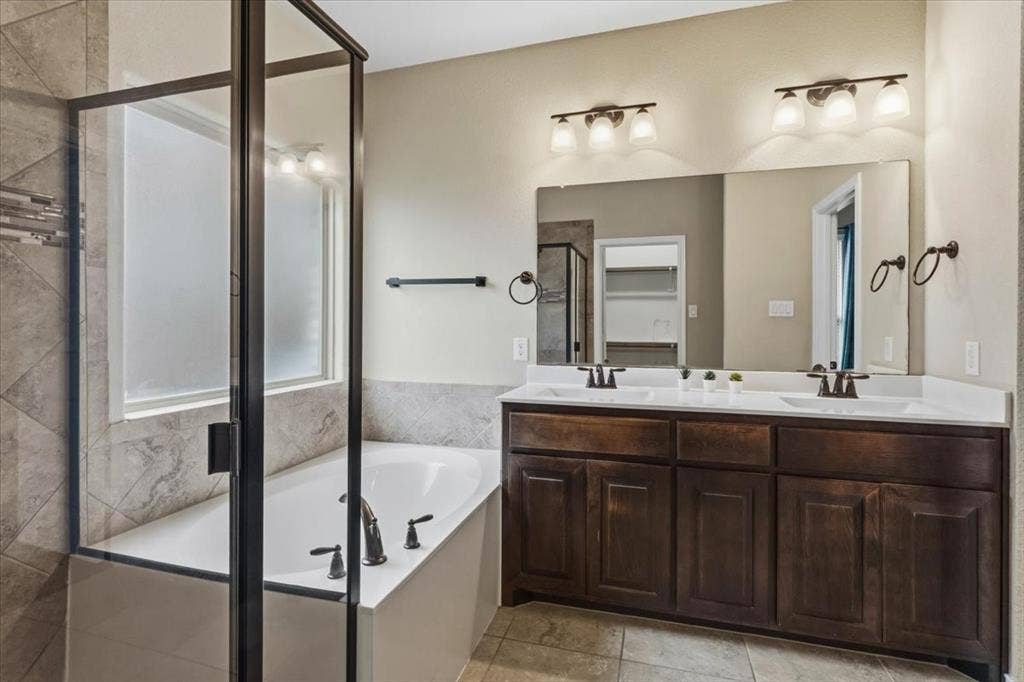 1713 Falling Star Drive, Fort Worth, TX 76052 Dual vanity with undermount sinks, white countertops, and dark wood-finish cabinetry