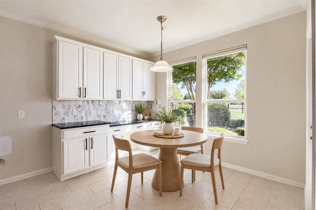 White shaker-style cabinetry with matte black hardware, Quartz countertops, and a patterned tile backsplash