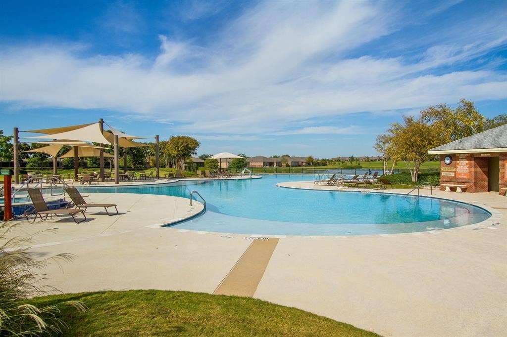 Expansive swimming pool with integrated spa and ample surrounding deck space