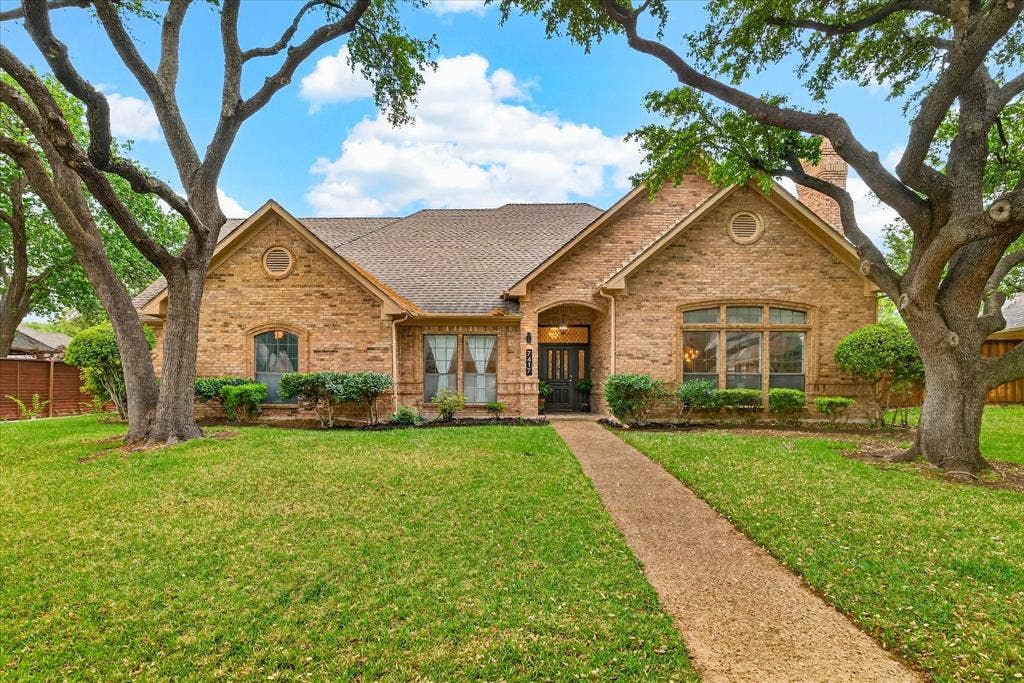 Brick exterior with a gabled roof and arched entryway
