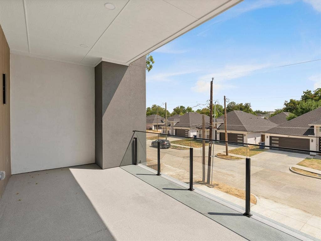 1711 Kraft Street, Dallas, TX 75212 Outdoor balcony with a glass and metal railing, recessed ceiling lighting, and a durable concrete surface