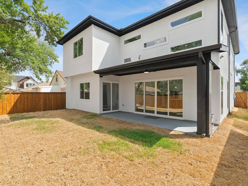 1711 Kraft Street, Dallas, TX 75212 Modern white stucco, covered patio, and sliding doors to master bedroom and living area.