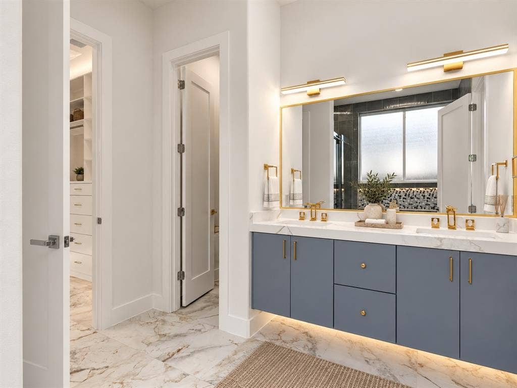 1711 Kraft Street, Dallas, TX 75212 Floating cabinetry, undermount sinks, lighting underneath cabinetry, and gold-finish fixtures.