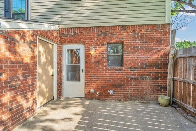 Brick exterior walls with a concrete patio