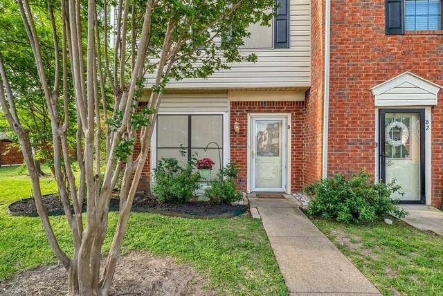 Brick and siding exterior with mature landscaping
