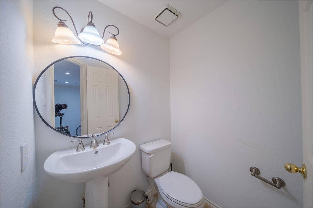 The half bathroom is located on the first level next to the front door.