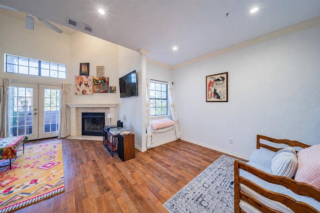 The living room is where the balcony is accessed. The dining room is located to the right in the photo.