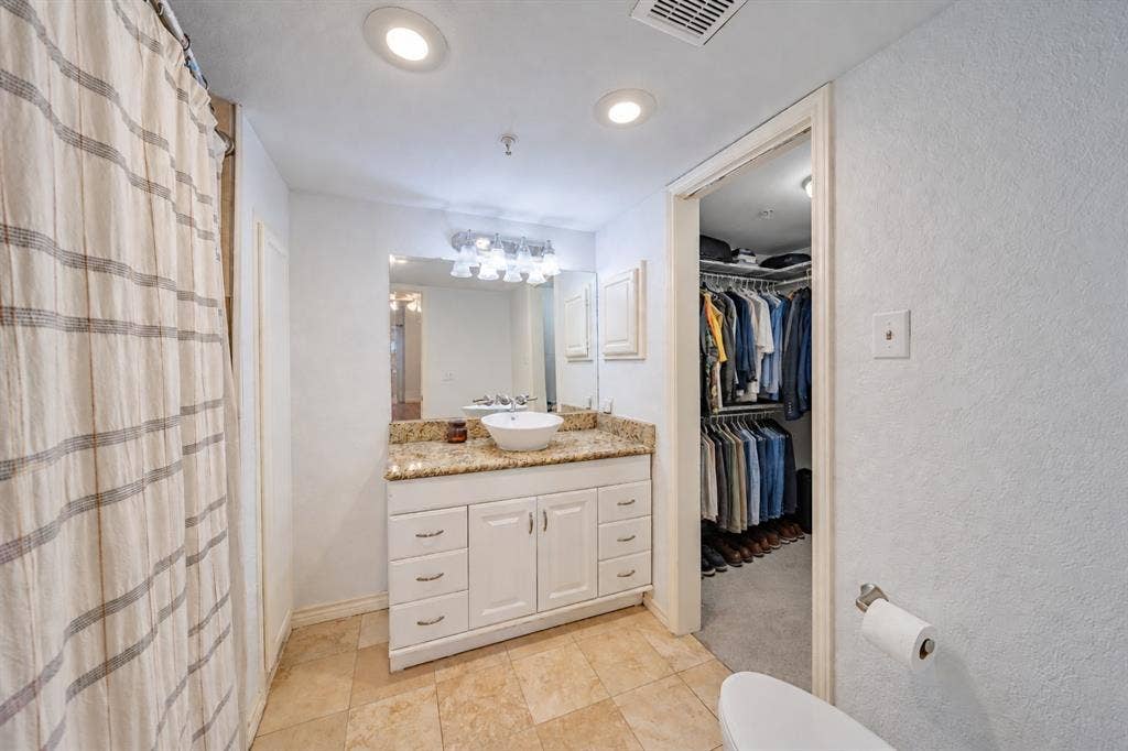 The full bath with tub and shower combination is located in the primary bedroom.  The door to the right is the full closet for the primary bedroom.