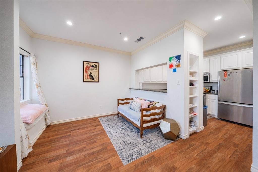 The dining room is located off of the kitchen and features a pass through to the kitchen. There is an additional storage shelf between the kitchen and dining room.