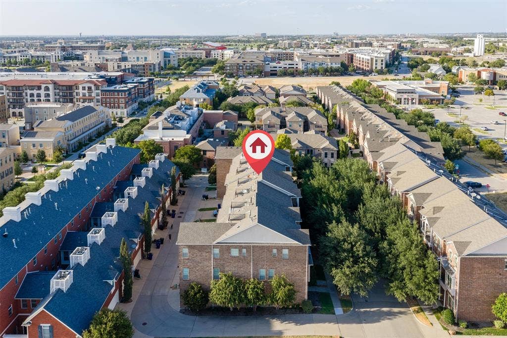 8249 Short Street, Frisco, TX 75034 Brick exterior townhome with a gabled roof and covered entry