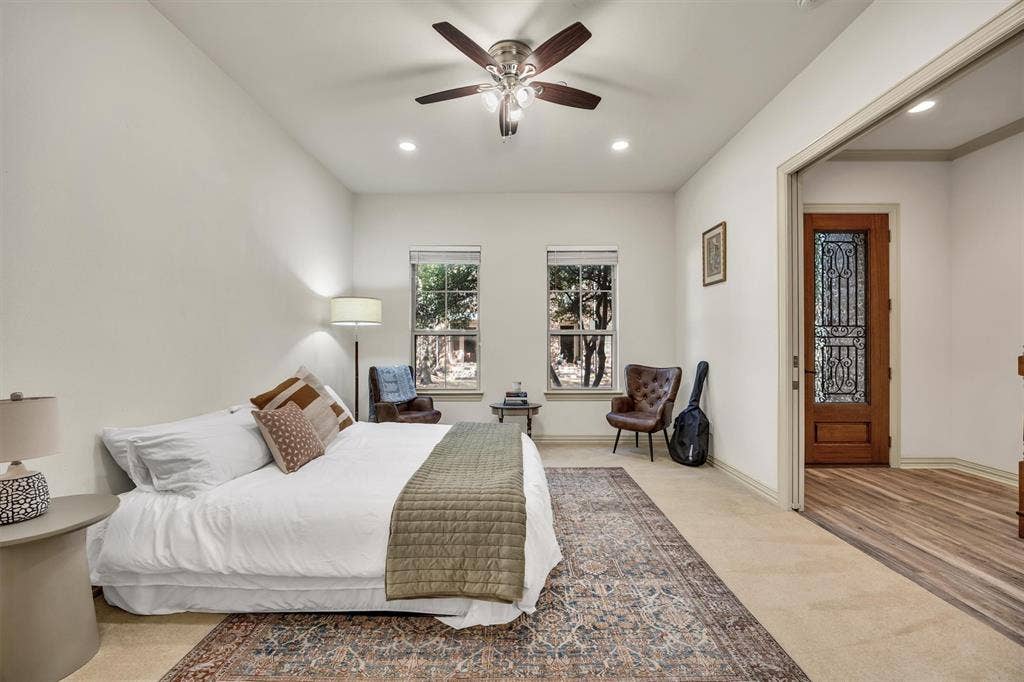 8249 Short Street, Frisco, TX 75034 Vaulted ceiling with a ceiling fan, recessed lighting, and two windows providing natural illumination