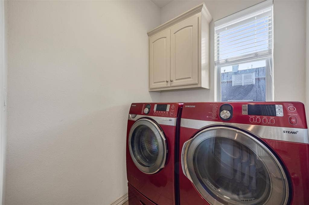8249 Short Street, Frisco, TX 75034 Cream-colored upper cabinetry with arched panel doors, and a window with horizontal blinds