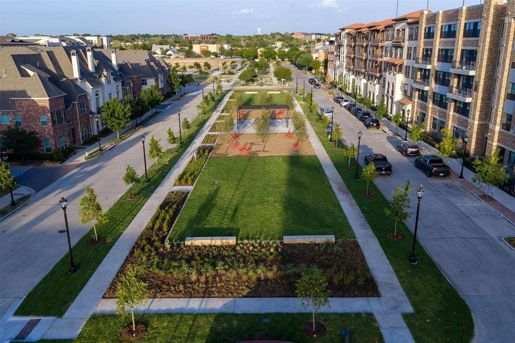 8249 Short Street, Frisco, TX 75034 Central green space with manicured lawn, established plantings, and paved walkways
