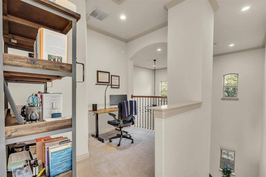 8249 Short Street, Frisco, TX 75034 Carpeted loft area featuring a dark wood-finish desk, recessed lighting, arched doorway, and white painted balusters