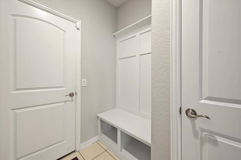 Built-in storage bench with paneling, multiple paneled doors, and contemporary hardware