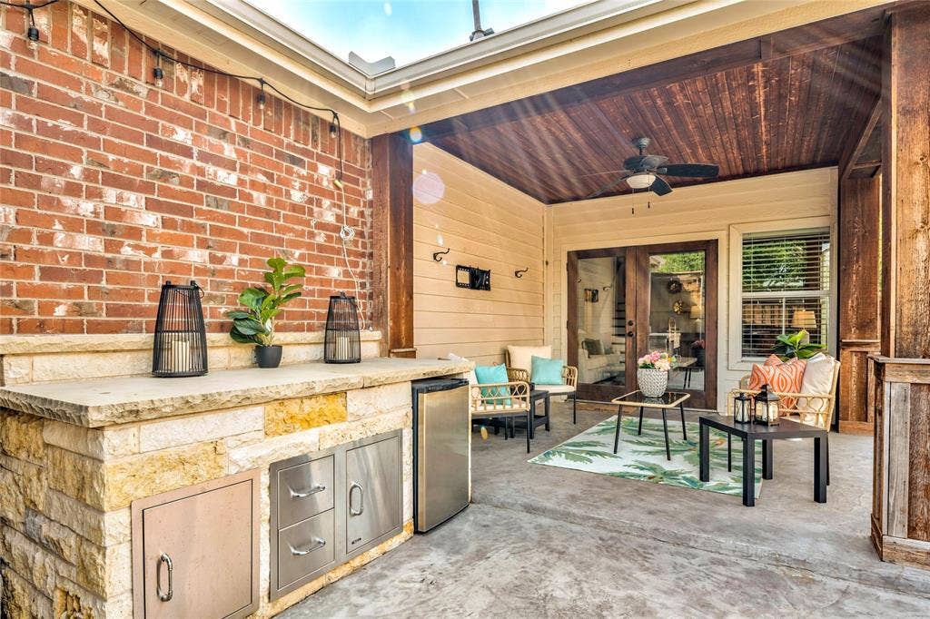10138 Planters Row Drive, Frisco, TX 75033 The covered patio features an outdoor counter with a gas line already in place, ready for your grill setup and game-day menu.